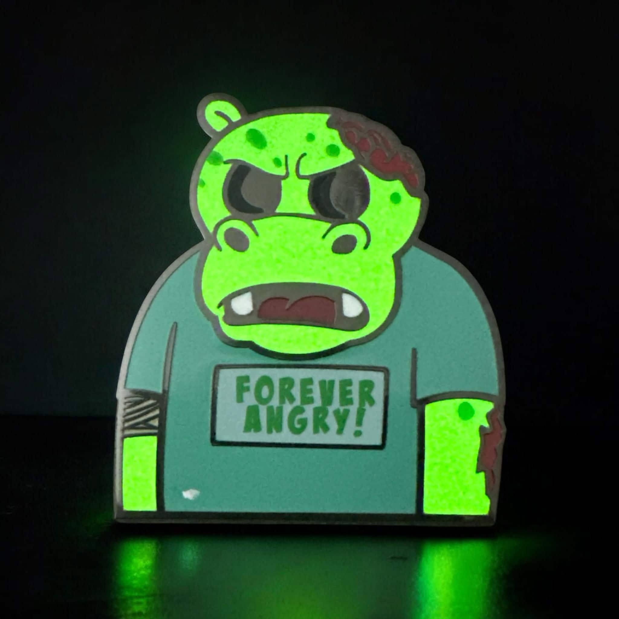 Hippo character called Bubbles in a neutral background image. Hippo is green in color and wearing a teeshirt that says Forever Angry! in green text. This is a zombie version of the original design.